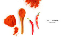 Creative Layout Made Of Red Chilli Pepper Powder, Chilli Pepper And Wood Spoon On A White Background. Top View.  