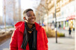 © pikselstock - Portrait of a young man standing in a city street, smiling