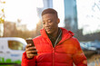 Young man using smart phone outdoors at urban setting
