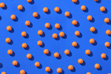 Spiral pattern of orange fruit isolated on a blue background