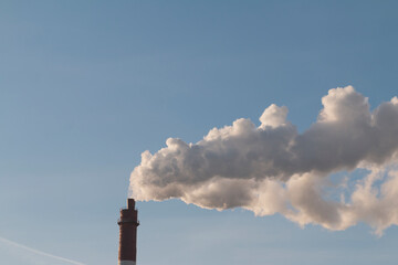 smoke from chimney against blue clear sky, environment pollution concept