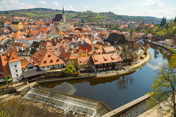 Wall Mural - Beautiful city on the river Bank, houses with red tile roofs. River around the town. Picturesque place. Sight.