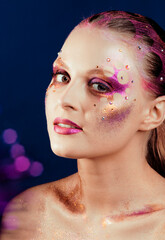 beauty young woman with creative make up, mystery tinsel