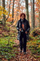 Tourist woman with camera in the forest