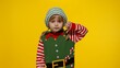 © Andrii Iemelianenko - Displesed blonde kid teen girl in Christmas elf Santa helper costume doesnt agree with ideas how to celebrate New Year keeps thumbs down, dislike gesture