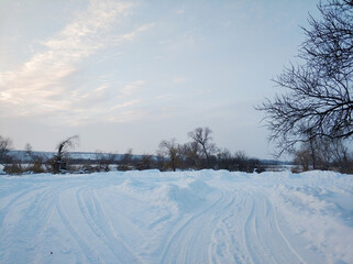 Wall Mural - Winter landscape. A distant village in the cold part of the planet. White snow covered road