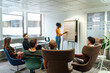 © David Prado/Stocksy - Group of business partners listening to presentation with flip chart at office