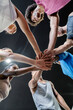 © Santi Nunez/Stocksy - Group of people joining hands together.