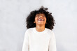 © Santi Nunez/Stocksy - Cute afro kid laughing.