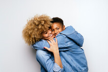 Black Boy In Studio Hugging His Mom.