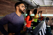 © Santi Nunez/Stocksy - People using treadmills at gym.
