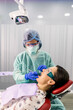 © Santi Nunez/Stocksy - Dentist With A Patient During A Dental Intervention.