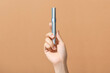 © Maki Company Limited/Stocksy - Mascara in hand isolated on a yellow