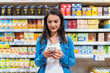 © Santi Nunez/Stocksy - Beautiful woman buying food in a supermarket