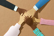 © Maki Company Limited/Stocksy - Friends with stack of hands showing unity and teamwork.