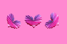 Studio Shot Of Three Pink And Purple Origami Hearts