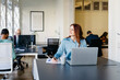 © JOSEP M ROVIROSA/Westend61 - Smiling businesswoman writing while looking away in office