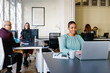 © JOSEP M ROVIROSA/Westend61 - Smiling businesswoman working on laptop at desk in office
