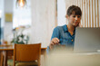 © KNSY/Westend61 - Female owner concentrating while using laptop sitting in cafe