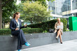 © PETE  MULLER/Westend61 - Businesswomen maintain social distancing while sitting at office park