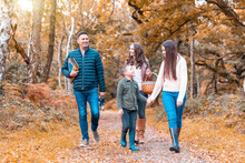 Happy Family Walking In Cannock Chase Park During Autumn