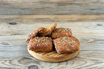 Wall Mural - Close up of rye multigrain bread on wooden background. Homemade bread for breakfast