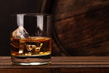 Fototapeta Tulipany - Scotch whiskey glass and old barrel