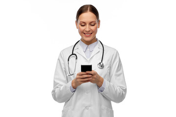 medicine, profession and healthcare concept - happy smiling female doctor with stethoscope using smartphone over white background