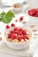 Wall Mural - Oatmeal porridge with raspberries and nuts in bowl