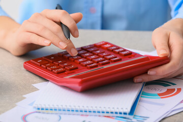 Wall Mural - Female accountant with calculator working in office, closeup