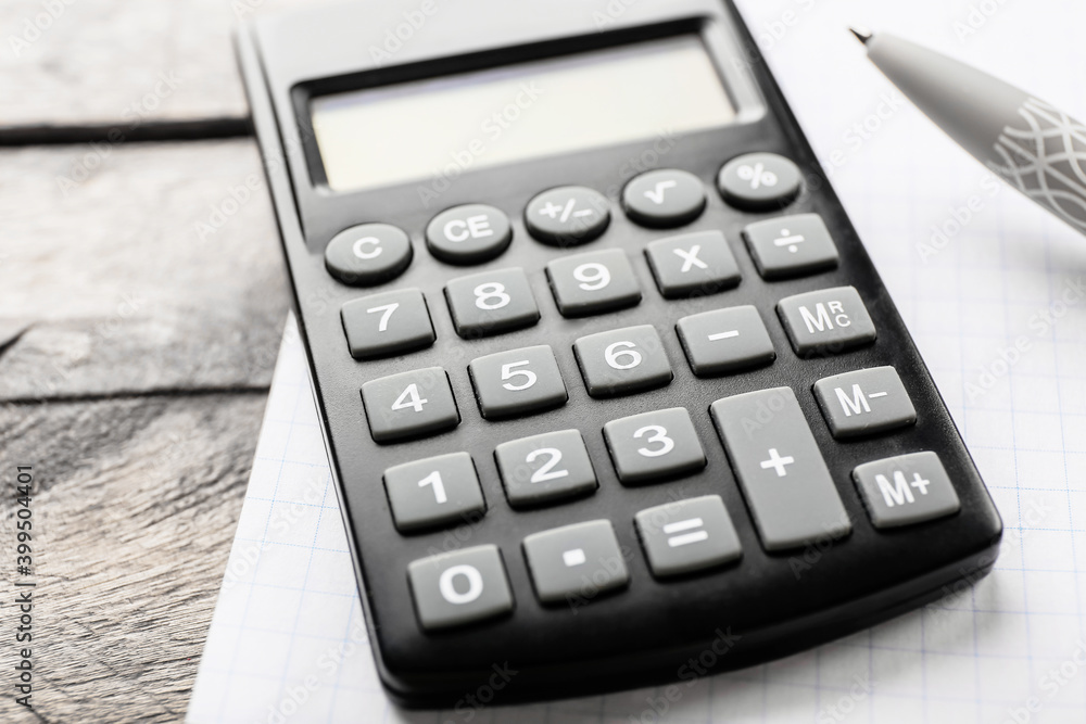 Modern calculator on wooden background, closeup