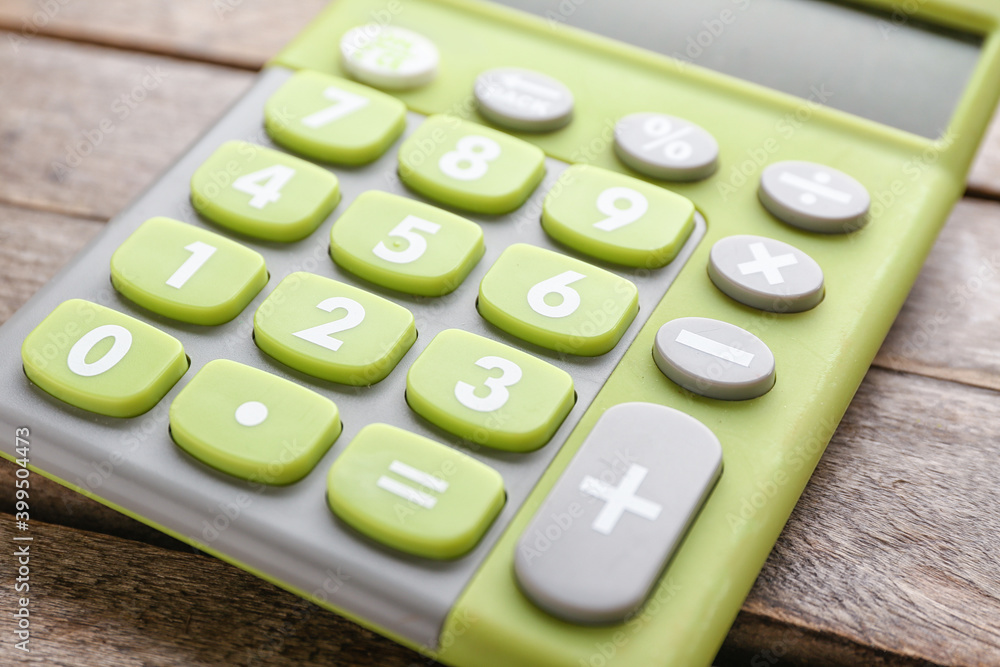 Modern calculator on wooden background, closeup
