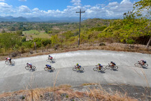 San Jose, Tarlac, Philippines - Professional Cyclists Race Along A Highway In Hilly Terrain. A National Road Cycling Competition.