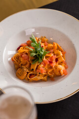 Wall Mural - fettuccine pomodoro pasta with tomatoes on white plate on the table