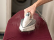 © 22Imagesstudio - Man hand ironing clothes on iron board.