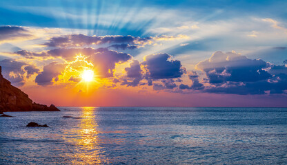 Wall Mural - calm sea and cloudy sky pierced with sun rays. beautiful nature background.