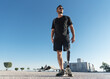 © 22Imagesstudio - Young disabled man with prosthetic leg outdoors, low angle shoot.