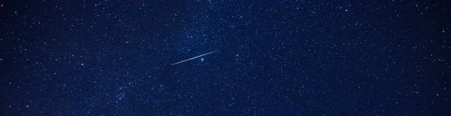 panorama blue night sky and geminids meteor shower 2020.with noise and grain.photo by long exposure 