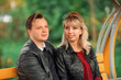 © Елизавета Шишова - A young couple-brown-haired and blonde-sit on a bench and hold hands
