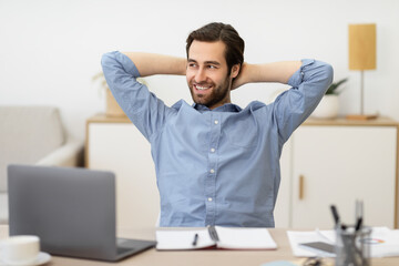 Wall Mural - Carefree Businessman Relaxing Sitting Holding Hands Behind Head At Workplace