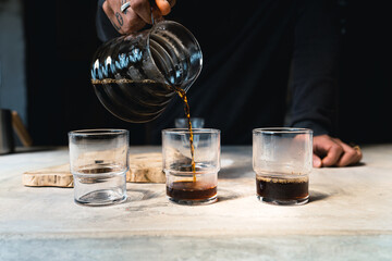 Wall Mural - Drip coffee, barista pouring water on coffee ground with filter