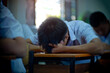 © arrowsmith2 - Students taking exam with stress in school classroom