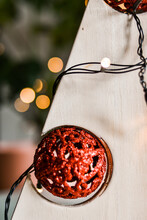 Close-up. Detail Of A Christmas Tree Made Of Wood With Red Christmas Ball And Lights. Shallow Depth Of Field.