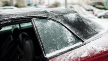 Frozen Glass And Roof Of A Convertible Car In Winter, Snow On The Tarpaulin.
