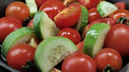 Wall Mural - Salad with tomatoes, olives oil, and cucumber on an iron plate, Fresh organic salad, Raw snack vegetable with olives oil as antipasti, Vegetable salad with cherry tomatoes on a dark background.