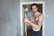 © Teodor Lazarev - Shirtless attractive man painting his walls