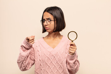 Sticker - young hispanic woman pointing forward at camera with both fingers and angry expression, telling you to do your duty