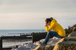 © Rob Wilkinson - woman sitting on rocks with her head in her hands.