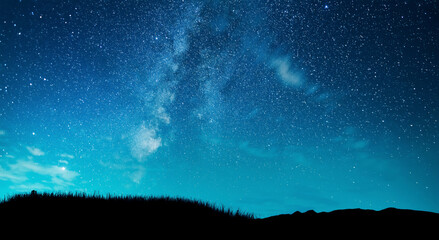 Beautiful milky way galaxy on the starry sky over the hill silhouette. Night photography Astronomical wallpaper.