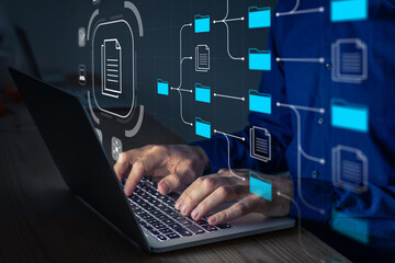 document management system (dms) being setup by it consultant working on laptop computer in office. 